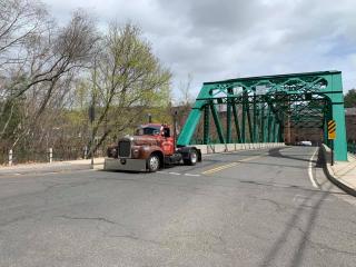 Truck Driving Near Green Bridge 